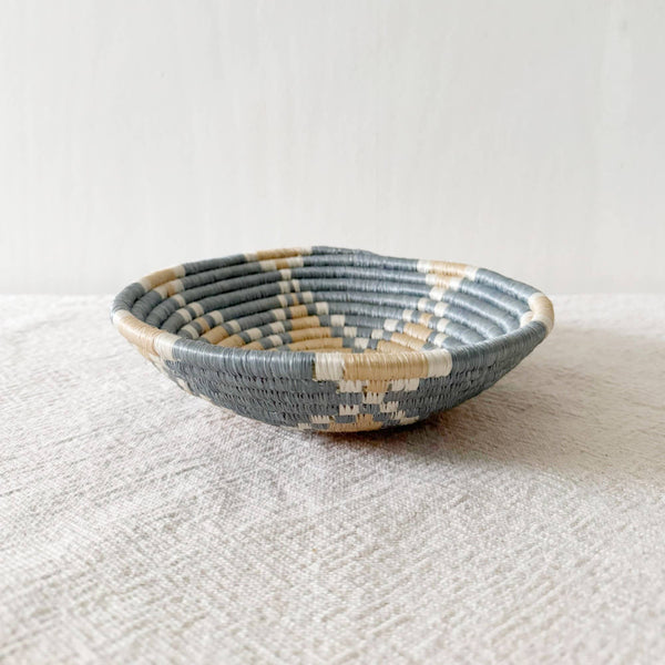 Woven basket on a textured surface with a light background