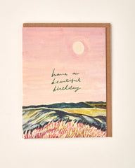 Greeting card with landscape illustration and 'Have a Beautiful Birthday' text on a pink background.