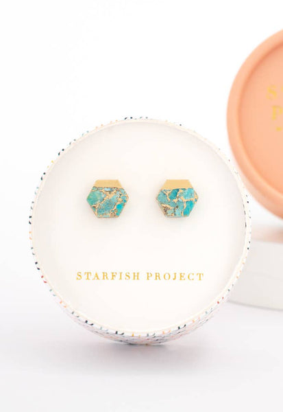 Turquoise earrings with gold accents in a 'Starfish Project' jewelry box on a white background