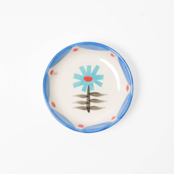 Small ceramic plate with floral design on a white background