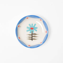 Small ceramic plate with floral design on a white background