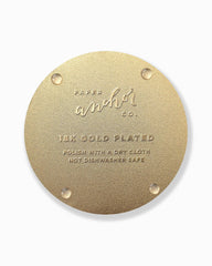 Gold circular coaster with 'Paper Anchor Co.' branding and text on a white background