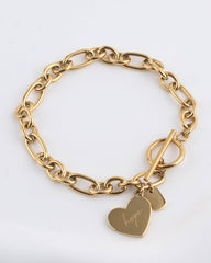 A gold-tone chain bracelet with a toggle clasp and two dangling heart charms, one engraved with the word 'hope', shown on a plain light background.