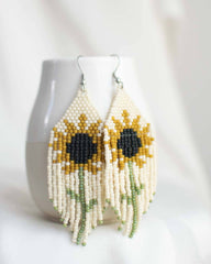 Sunflower-themed beaded earrings on a white background