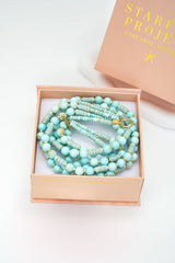 Turquoise beaded necklace in a pink box with 'Starfish Project' branding on a white background