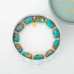 Turquoise beaded bracelet with gold accents in a white box, branded 'Starfish Project'.