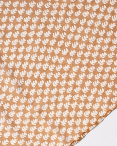 Three patterned scarves in orange, blue, and pink on a white background