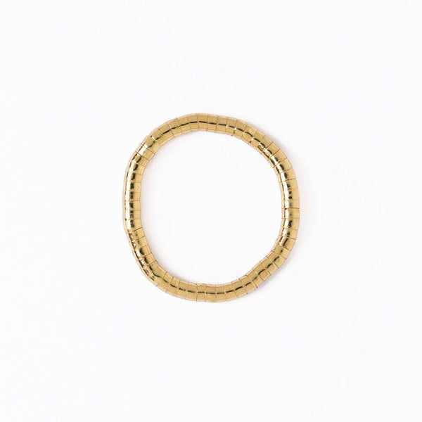 Gold bracelet with a textured design on a white background