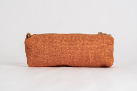 A rectangular zippered pouch in a textured rust-orange fabric, shown against a plain white background.