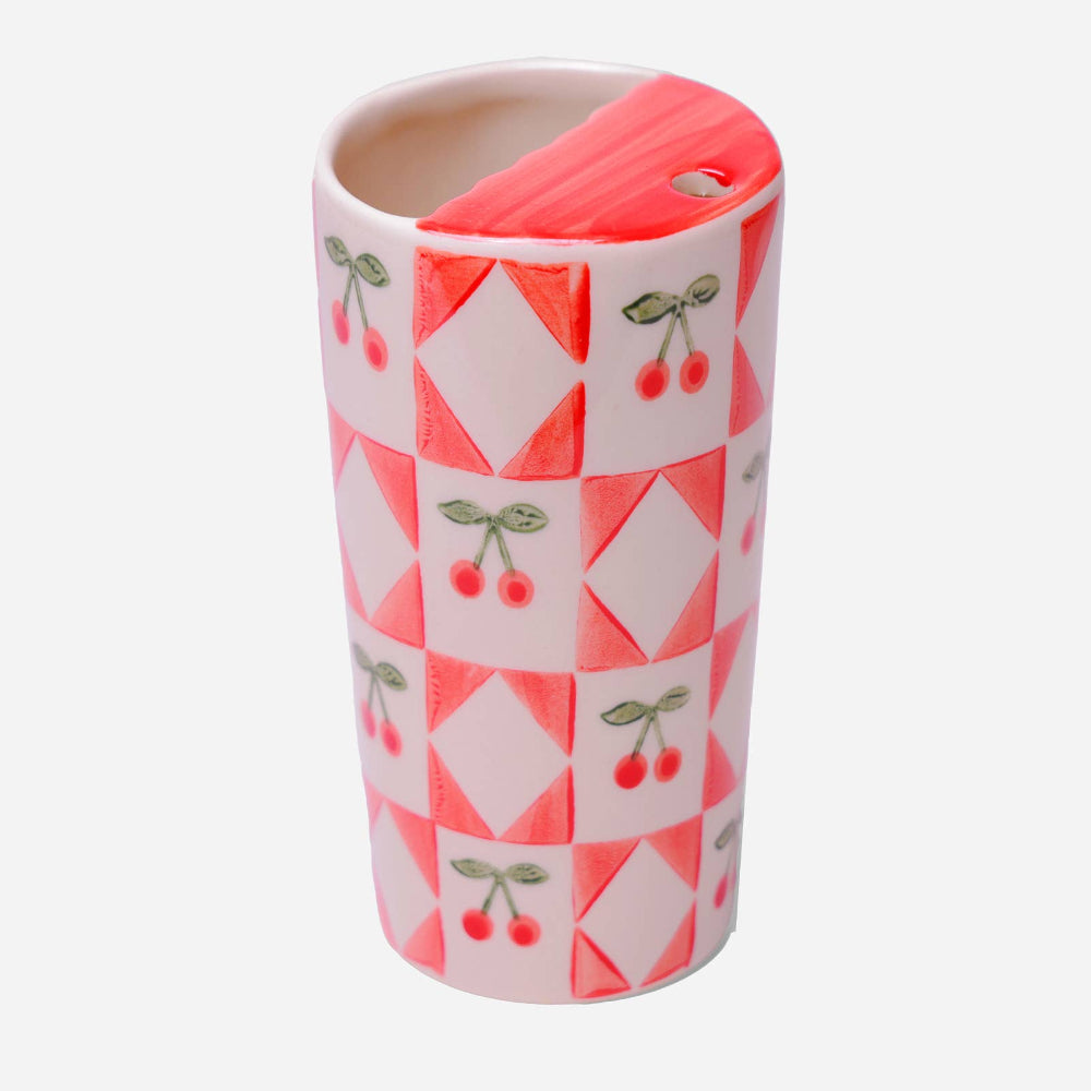 Tumbler with geometric pattern and cherry design on a white background