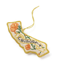 An embroidered California-shaped ornament with a gold border, orange poppy flowers, green leaves, and a banner reading 'CALIFORNIA' on a white background.