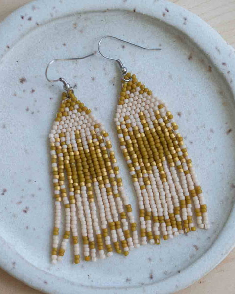 Beaded earrings on a textured ceramic plate