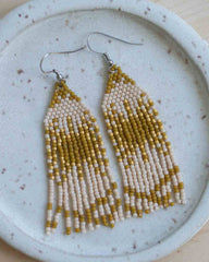 Beaded earrings on a textured ceramic plate