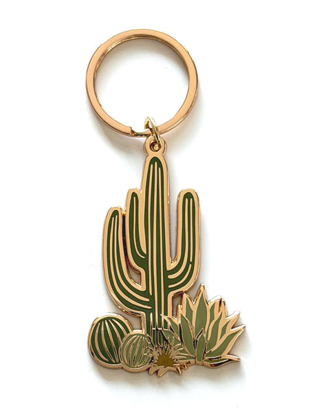 Cactus-shaped keychain with a rose gold ring on a white background