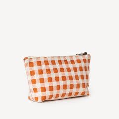 Small pouch with orange and white checkered pattern on a white background