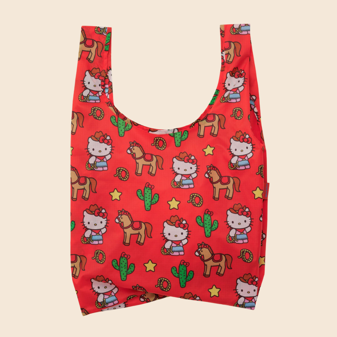 Red reusable baggu bag with Hello Kitty and horse pattern on a beige background