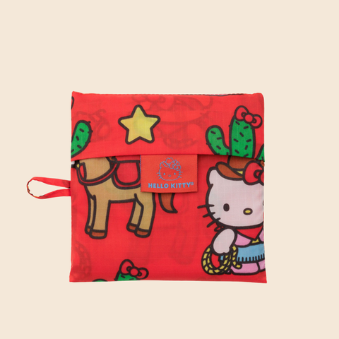 Red pouch with Hello Kitty design featuring cacti and a star on a beige background