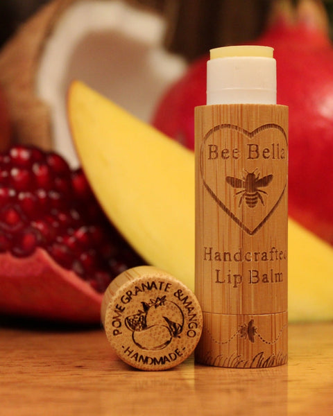 Lip balm with wooden container on a table with fruits in the background