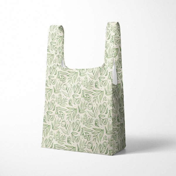 Reusable shopping bag with green leaf pattern on a white background