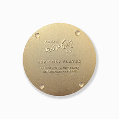 Gold circular tag with 'Paper Anchor Co.' branding and text on a white background