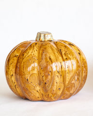 Decorative pumpkin with a marbleized gold and brown pattern on a white background