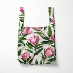 Reusable shopping bag with pink floral design on a white background