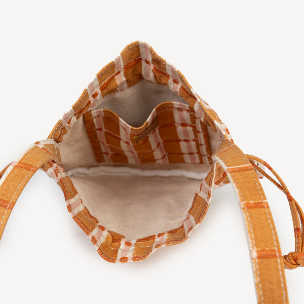 Small bag with plaid interior on a white background