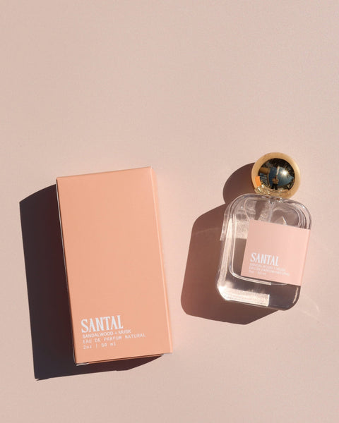 Perfume bottle and packaging on a beige background