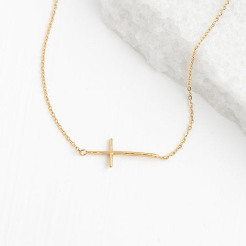 This delicate 14k gold-plated cross necklace is a timeless symbol of fai...
