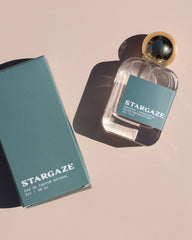 Stargaze perfume bottle and packaging on a beige background