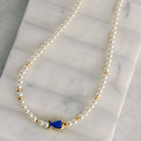 This Pearl Fish Necklace features a beautiful combination of faux pearls...