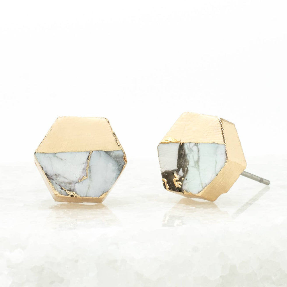 Hexagonal earrings with gold and marble design on a white background